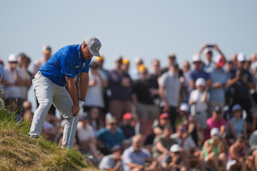 Bryson DeChambeau of the United States plays from an awkward lie to the 5th green during the second day of the British Open Golf championships at Royal Birkdale golf club, in Southport, England, Friday, July 17, 2026. (AP Photo/David Goldman)