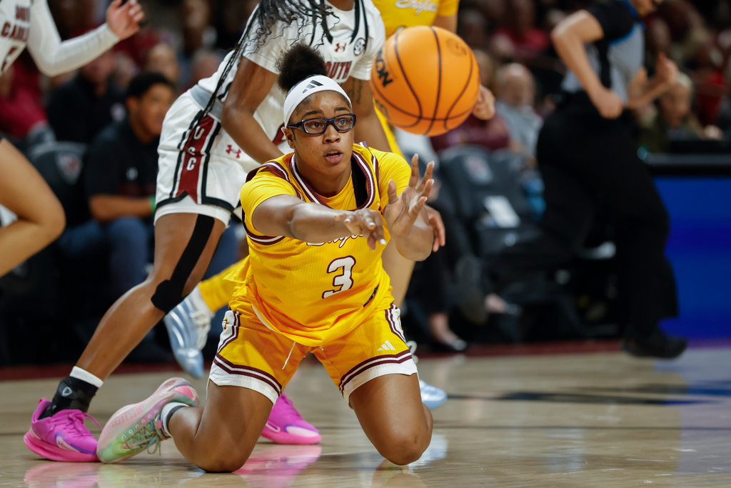 Winthrop guard Madison Ruff passes after recovering a loose ball against South Carolina during the first half of an NCAA college basketball game in Columbia, S.C., Wednesday, Nov. 19, 2025. (AP Photo/Nell Redmond)