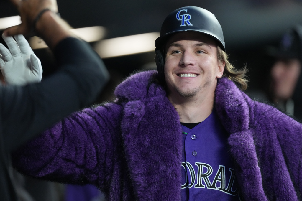Colorado Rockies' Jake McCarthy is congratulated as he returns to the dugout after hitting a two-run home run off San Francisco Giants starting pitcher Adrian Houser in the fourth inning of a baseball game Saturday, May 30, 2026, in Denver. (AP Photo/David Zalubowski)