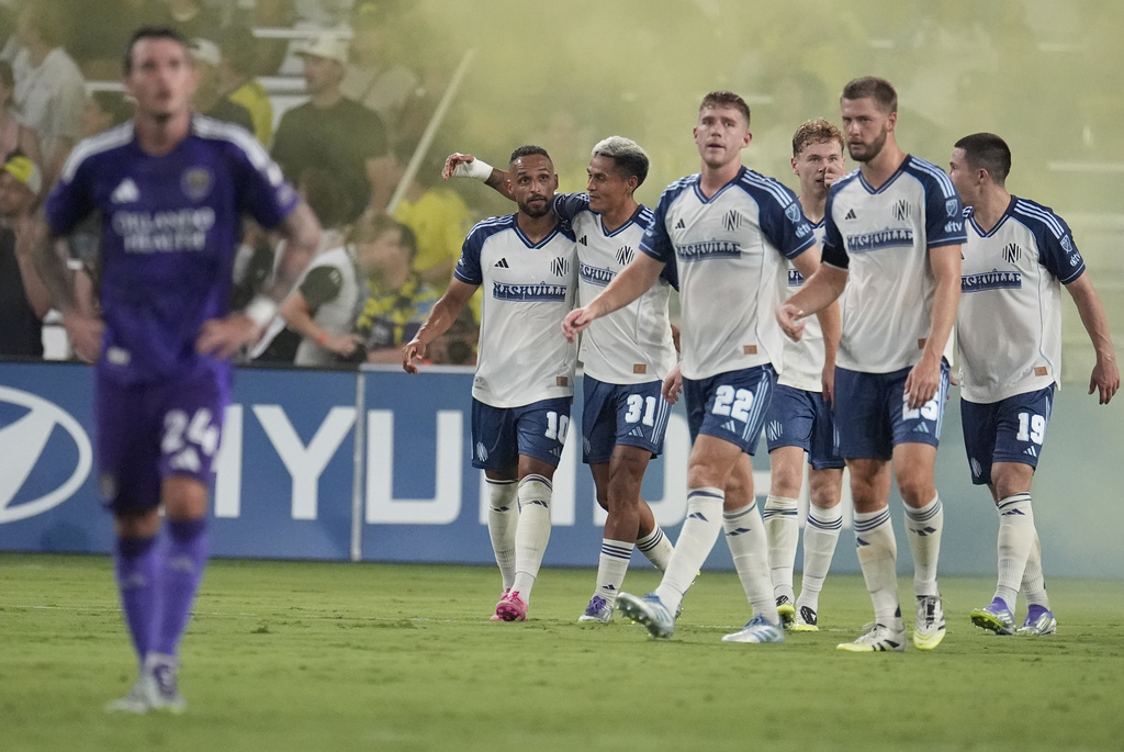 Nashville SC midfielder Hany Mukhtar (10) is congratulated by teammate midfielder Andy Najar (31) after scoring a goal during the first half of an MLS soccer match against Orlando City, Saturday, Aug. 23, 2025, in Nashville, Tenn. (AP Photo/George Walker IV)