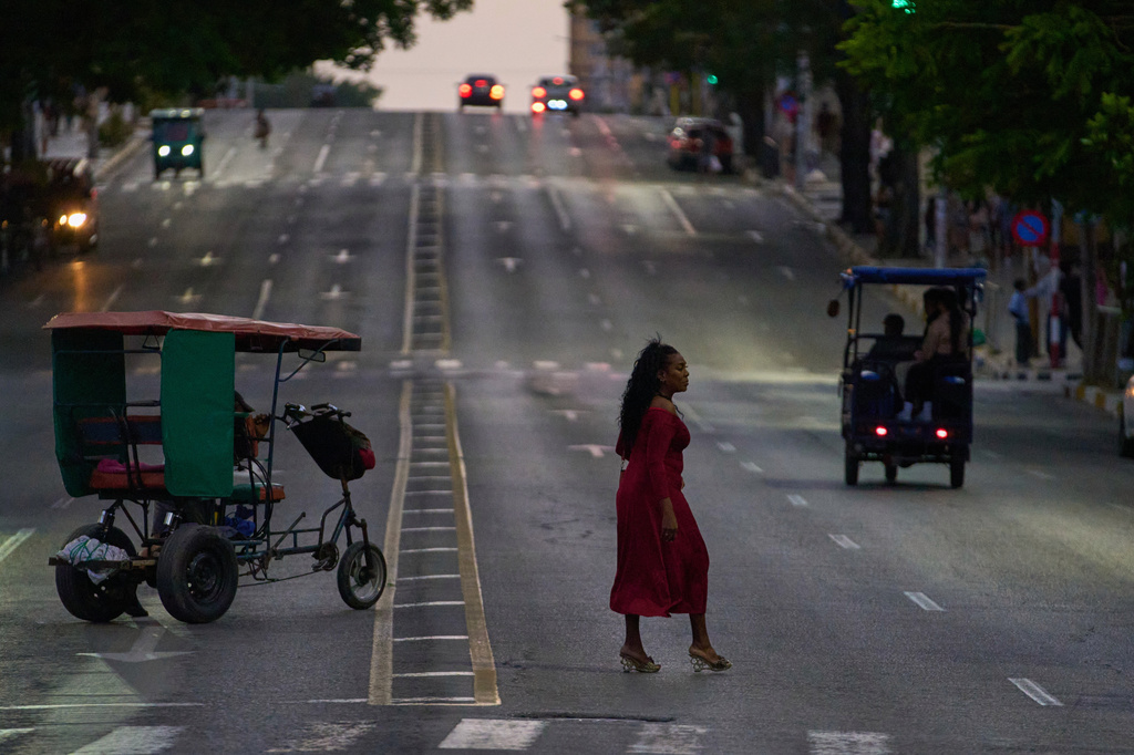 A woman crosses an avenue in Havana, Wednesday, April 15, 2026. (AP Photo/Ramon Espinosa)