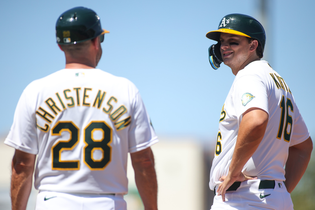 Athletics' Nick Kurtz, right, smiles at first base coach Ryan Christenson (28) after being intentionally walked during the seventh inning of a baseball game against the Kansas City Royals, Thursday, April 30, 2026, in West Sacramento, Calif. (AP Photo/Scott Marshall)