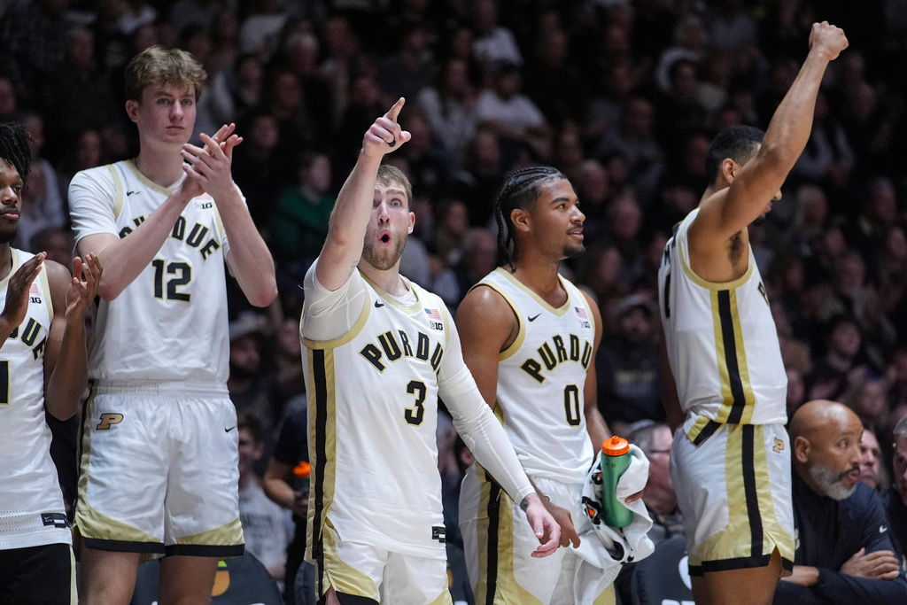 Purdue players, left, to right, Daniel Jacobsen, Braden Smith, C.J. Cox, and Trey Kaufman-Renn celebrate on the bench during the second half of an NCAA college basketball game against Akron in West Lafayette, Ind., Sunday, Nov. 16, 2025. (AP Photo/Michael Conroy)