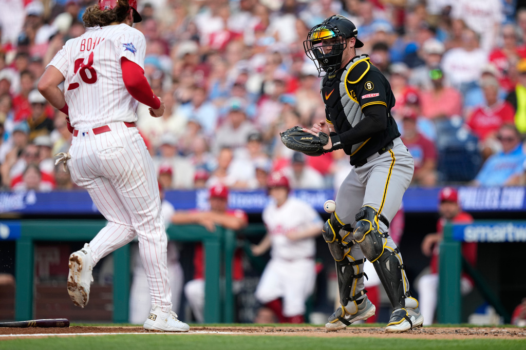 Philadelphia Phillies' Alec Bohm, left, scores past Pittsburgh Pirates catcher Henry Davis on a two-run fielder's choice hit by Justin Crawford during the second inning of a baseball game Wednesday, July 1, 2026, in Philadelphia. (AP Photo/Matt Slocum)