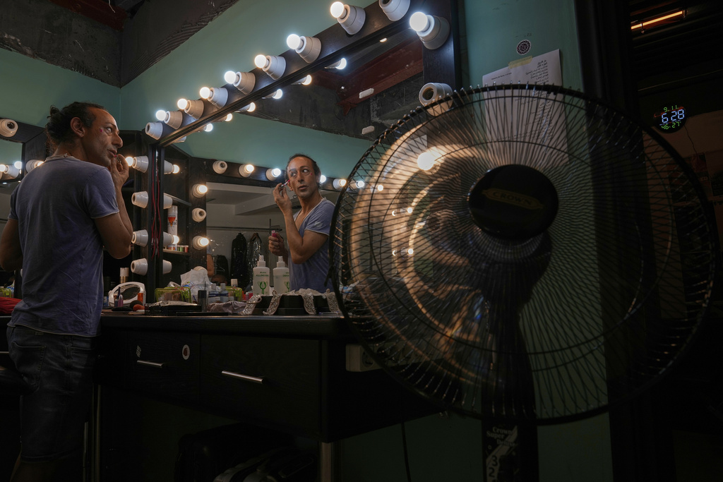 Alexandre Paulikevitch applies makeup backstage before performing at a theatre in Beirut, Lebanon, Thursday, Sept. 11, 2025. (AP Photo/Hussein Malla)