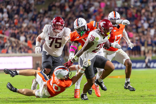 Virginia safety Ethan Minter (30) makes a tackle during a run by Washington State running back Leo Pulalasi (20) during the first half of an NCAA college football game, Saturday, Oct. 18 2025, in Charlottesville, Va. (AP Photo/Robert Simmons) Virginia safety Ethan Minter (30) makes a tackle during a run by Washington State running back Leo Pulalasi (20) during the first half of an NCAA college football game, Saturday, Oct. 18 2025, in Charlottesville, Va. (AP Photo/Robert Simmons)