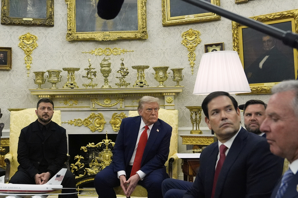 President Donald Trump listens to a question from a reporter as he meets with Ukraine's President Volodymyr Zelenskyy in the Oval Office at the White House, Monday, Aug. 18, 2025, in Washington, from right Steve Witkoff, special envoy to the Middle East,, Secretary of State Marco Rubio and Vice President JD Vance listen. (AP Photo/Julia Demaree Nikhinson)