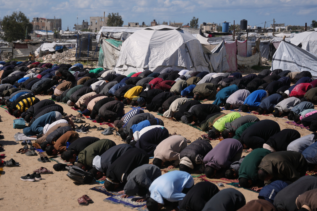 Muslim worshippers perform Friday prayers during the holy month of Ramadan outside the destroyed Al-Albani Mosque, in Khan Younis, southern Gaza Strip, Friday, Feb. 27, 2026. (AP Photo/Abdel Kareem Hana)