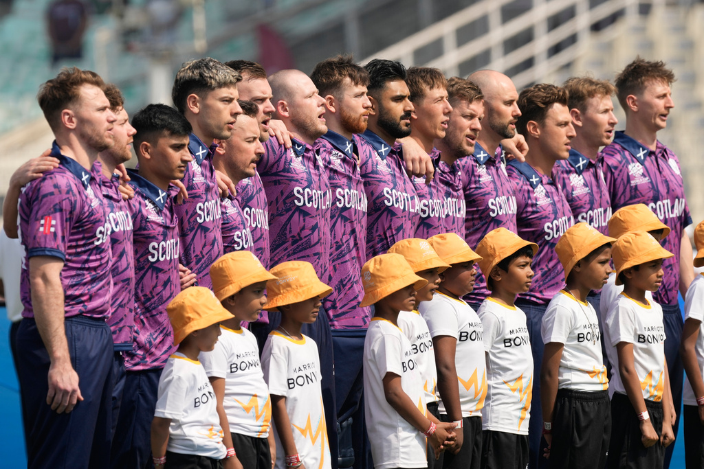 Scotland players stand for the national anthems of the respective countries before the start of the T20 World Cup cricket match between them in Kolkata, India, Monday, Feb. 9, 2026. (AP Photo/Bikas Das)