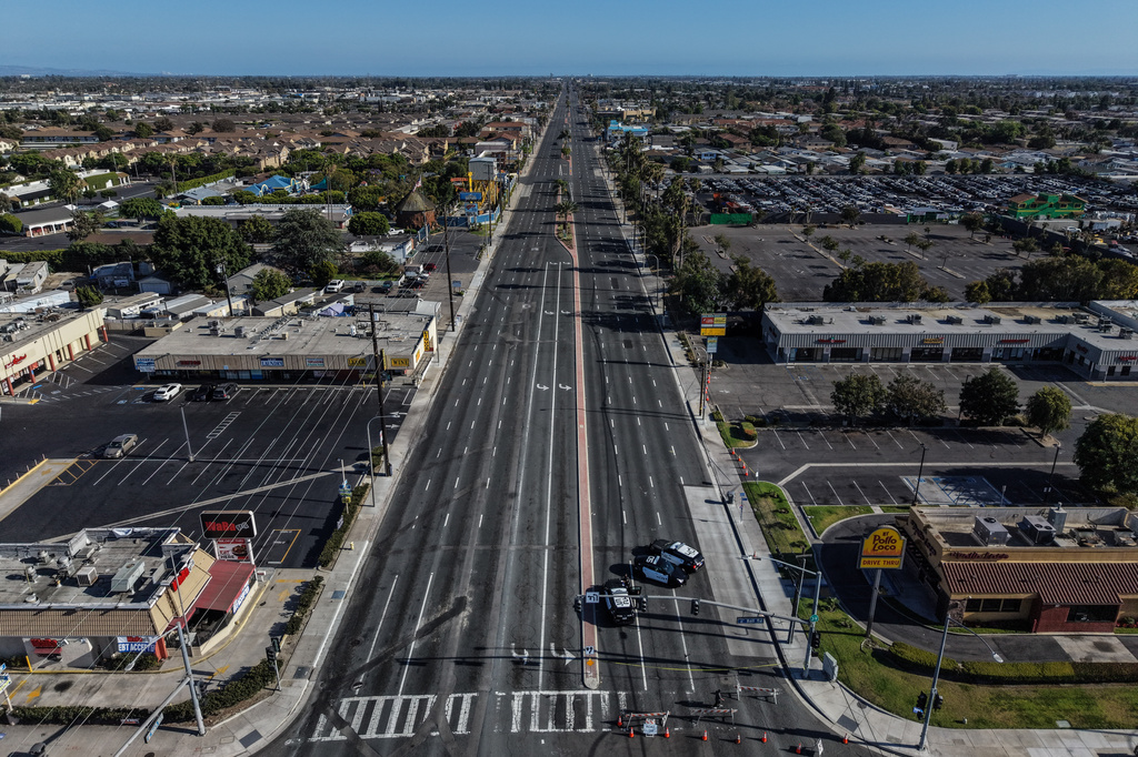 An aerial view shows a police checkpoint enforcing a road closure at the evacuation zone boundary in Anaheim, Calif., Monday, May 25, 2026. (AP Photo/Jae C. Hong)