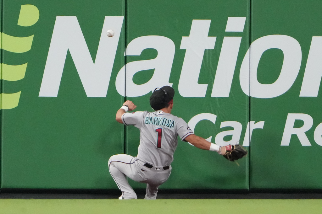 Arizona Diamondbacks center fielder Jorge Barrosa is unable to catch a triple by St. Louis Cardinals' Lars Nootbaar during the ninth inning of a baseball game Wednesday, June 24, 2026, in St. Louis. (AP Photo/Jeff Roberson)