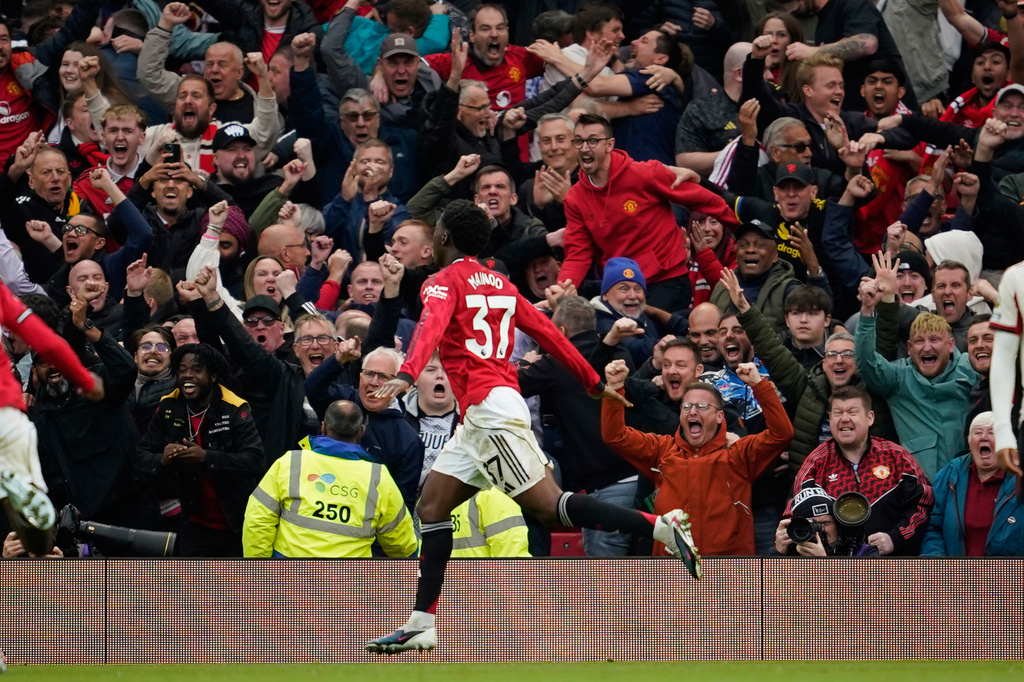 Manchester United's Kobbie Mainoo celebrates after scoring his side's third goal during the English Premier League soccer match between Manchester United and Liverpool in Manchester, England, Sunday, May 3, 2026. (AP Photo/Dave Thompson)