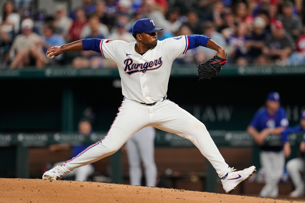 Texas Rangers pitcher Kumar Rocker throws to the Washington Nationals in the fourth inning of a baseball game Wednesday, Aug. 19, 2026, in Arlington, Texas. (AP Photo/Tony Gutierrez)
