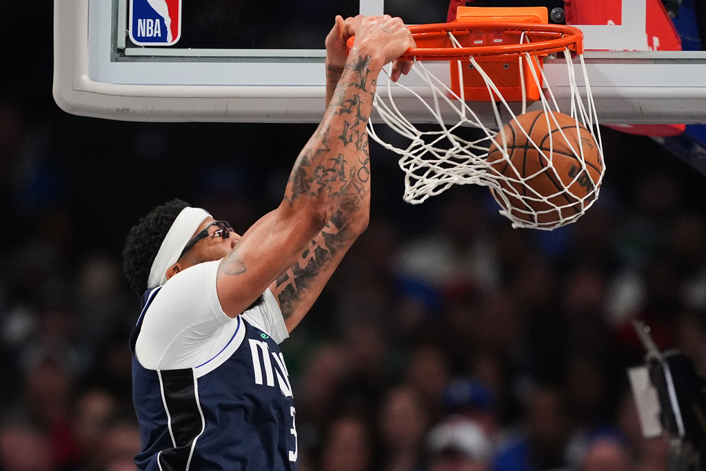 Dallas Mavericks forward Anthony Davis dunks in the second half of an NBA basketball game against the Brooklyn Nets in Dallas, Friday, Dec. 12, 2025. (AP Photo/Tony Gutierrez)