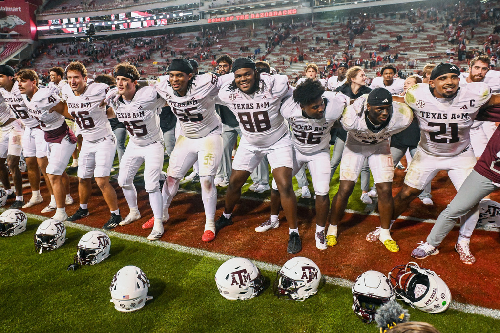 Texas A&amp;M players celebrate in front of their fans after defeating Arkansas during an NCAA college football game Saturday, Oct. 18, 2025, in Fayetteville, Ark. (AP Photo/Michael Woods)