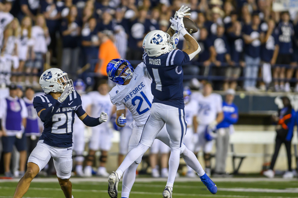 Utah State cornerback Noah Avenger (1) intercepts the pass intended for Air Force wide receiver Cade Harris (21) during the first half of an NCAA college football game, Saturday, Sept. 13, 2025, in Logan, Utah. (AP Photo/Tyler Tate)