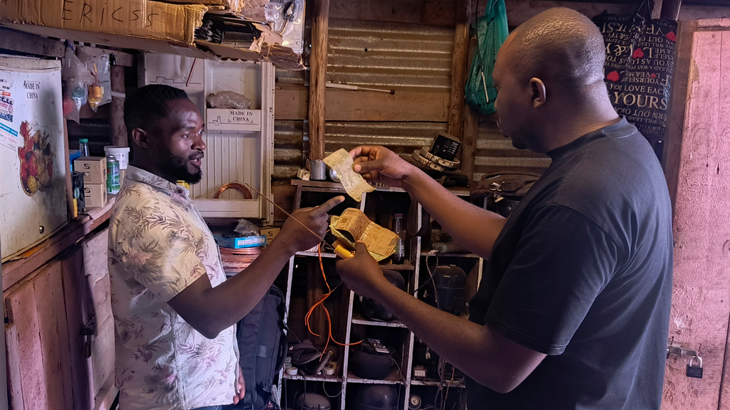 A customer pays for a service with perforated notes, which are rejected in Bukavu, Democratic Republic of the Congo, Friday, Aug 29, 2025. (AP Photo)