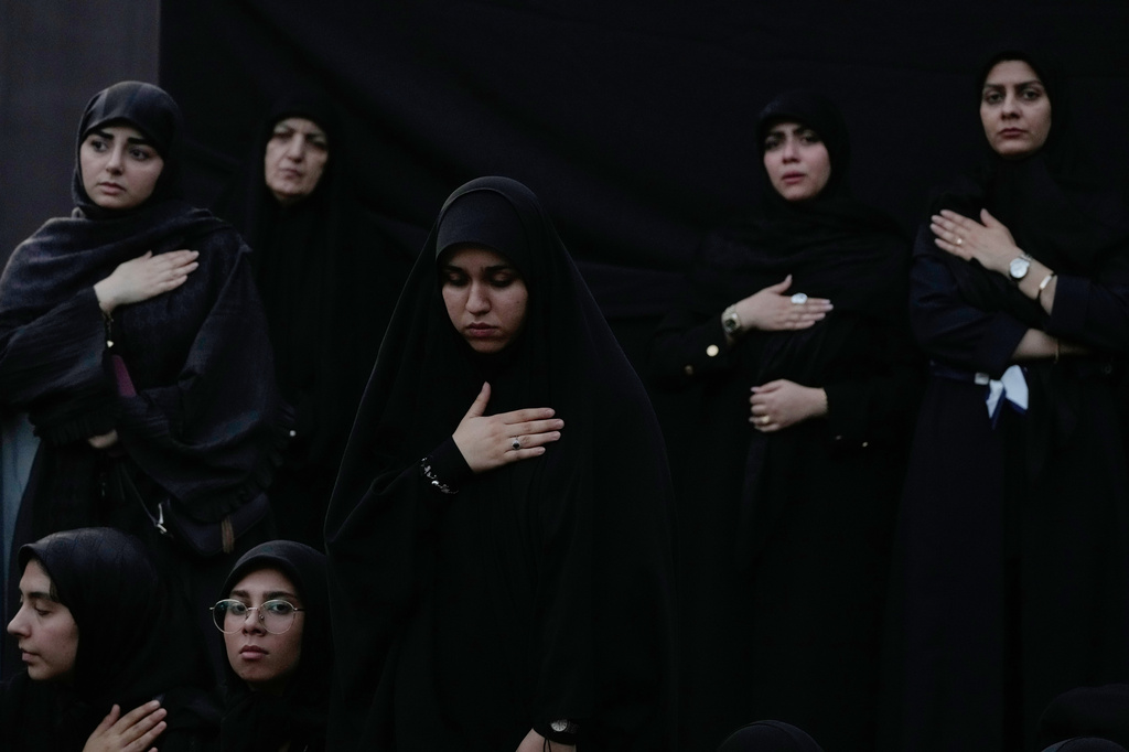 Women beat their chests during a mourning ceremony in Tehran, Iran, Thursday, June 18, 2026, ahead of Ashoura, which honors the 7th-century martyrdom of the Prophet Muhammad's grandson, Hussein, who was killed in a battle in Karbala in present-day Iraq. (AP Photo/Vahid Salemi)