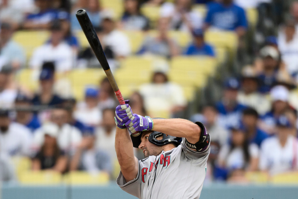 Arizona Diamondbacks' Ryan Waldschmidt hits a sacrifice fly during the fifth inning of a baseball game against the Los Angeles Dodgers in Los Angeles, Sunday, July 12, 2026. (AP Photo/Kyusung Gong)