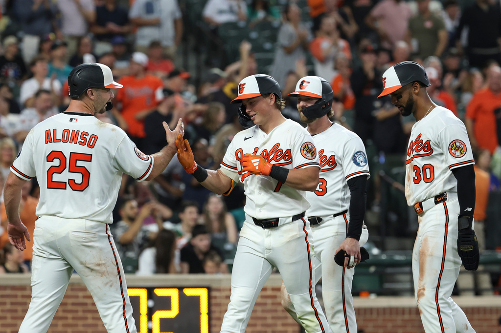 Baltimore Orioles' Jackson Holliday, center, celebrates his grand slam home run with Pete Alonso (25) hit off Seattle Mariners pitcher Domingo Gonzalez which scored Taylor Ward, Pete Alonso and Leody Taveras during the seventh inning of a baseball game, Wednesday, June 10, 2026, in Baltimore. (AP Photo/Terrance Williams)
