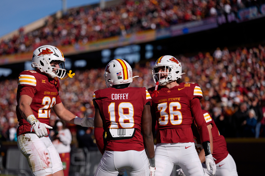 Iowa State defensive back David Coffey (18) celebrates breaking up a pass in the end zone with defensive back's Drew Surges (29) and Carson Van Dinter (36) during the first half of an NCAA college football game against Kansas, Saturday, Nov. 22, 2025, in Ames, Iowa. (AP Photo/Matthew Putney)