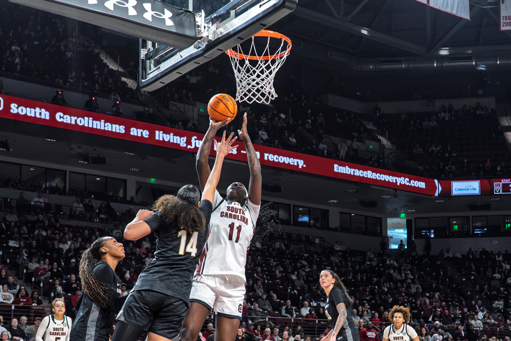 South Carolina center Madina Okot (11) shoots the ball over Vanderbilt forward Aiyana Mitchell (14) during the first half of an NCAA college basketball game Sunday, Jan. 25, 2026, in Columbia, S.C. (AP Photo/David Yeazell)