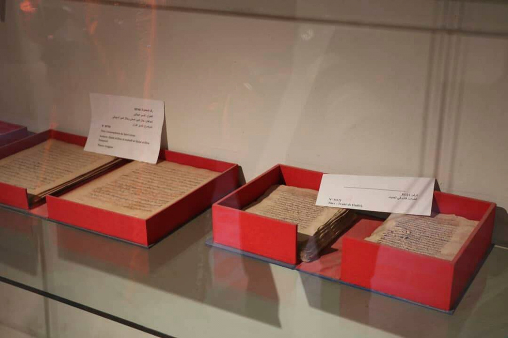 Ancient Timbuktu manuscripts are displayed in glass cases in Timbuktu, Mali after being returned to the city from Bamako, where they were kept for more than a decade, Monday, Aug. 11, 2025. (AP Photo/Moulaye Sayah)