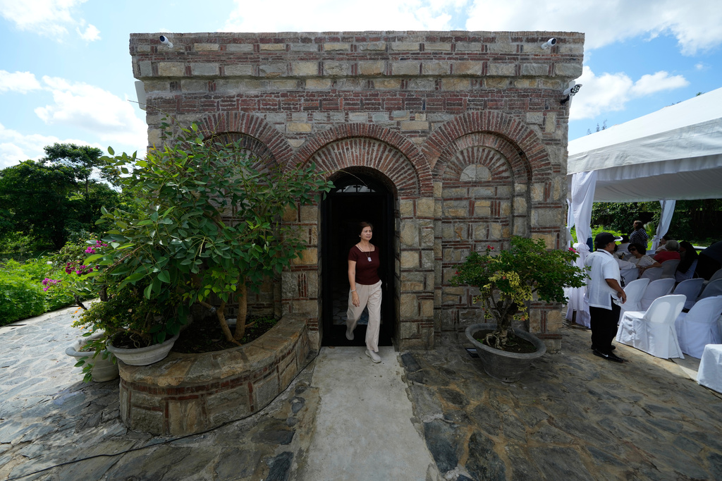 A Catholic devotee walks outside the Ephesus House, a replica of the House of the Virgin Mary in Ephesus, Turkey, at Alfonso town, Cavite province, Philippines on July 16, 2026. (AP Photo/Aaron Favila)