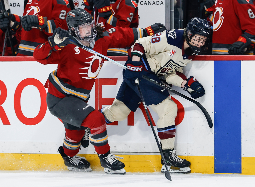 Ottawa Charge's Rory Guilday (5) defends against Montreal Victoire's Catherine Dubois (28) during first period PWHL hockey game action in Winnipeg, Canada, Sunday, March 22, 2026. (John Woods/The Canadian Press via AP)