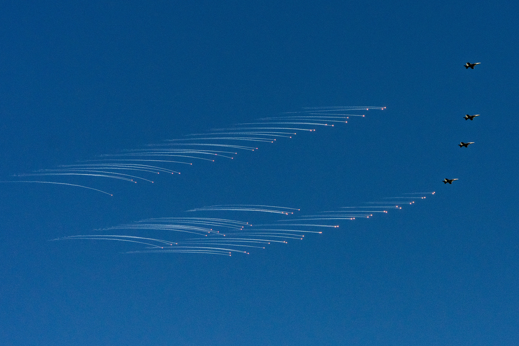 F/A-18 fighter aircraft drop bombs as President Donald Trump and first lady Melania Trump watch a naval sea power demonstration aboard the USS George H.W. Bush aircraft carrier in the Atlantic Ocean off the coast of Norfolk, Va., Oct. 5, 2025. (AP Photo/Alex Brandon)