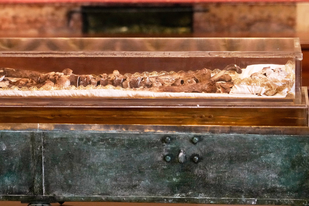 The remains of Francis of Assisi are displayed in a glass case inside the Basilica of St. Francis of Assisi in Assisi, Italy, Saturday, Feb. 21, 2026, on the eve of a public exposition beginning Feb. 22 to mark the 800th anniversary of his death in 1226. (AP Photo/Gregorio Borgia)