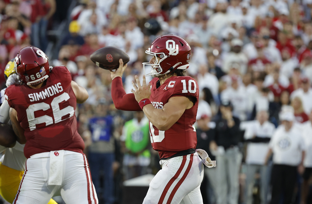 Oklahoma quarterback John Mateer (10)looks to pass the ball against Michigan during the first half of an NCAA college football game Saturday, Sept. 6, 2025, in Norman, Okla. (AP Photo/Alonzo Adams)