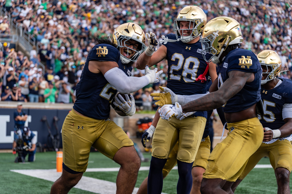 Notre Dame linebacker Kyngstonn Viliamu-Asa (27), safety Adon Shuler, and safety Luke Talich (28) celebrate a fumble recovery during the first half of an NCAA college football game against Rice, Saturday, Sept. 12, 2026, in South Bend, Ind. (AP Photo/Paul Barnick)