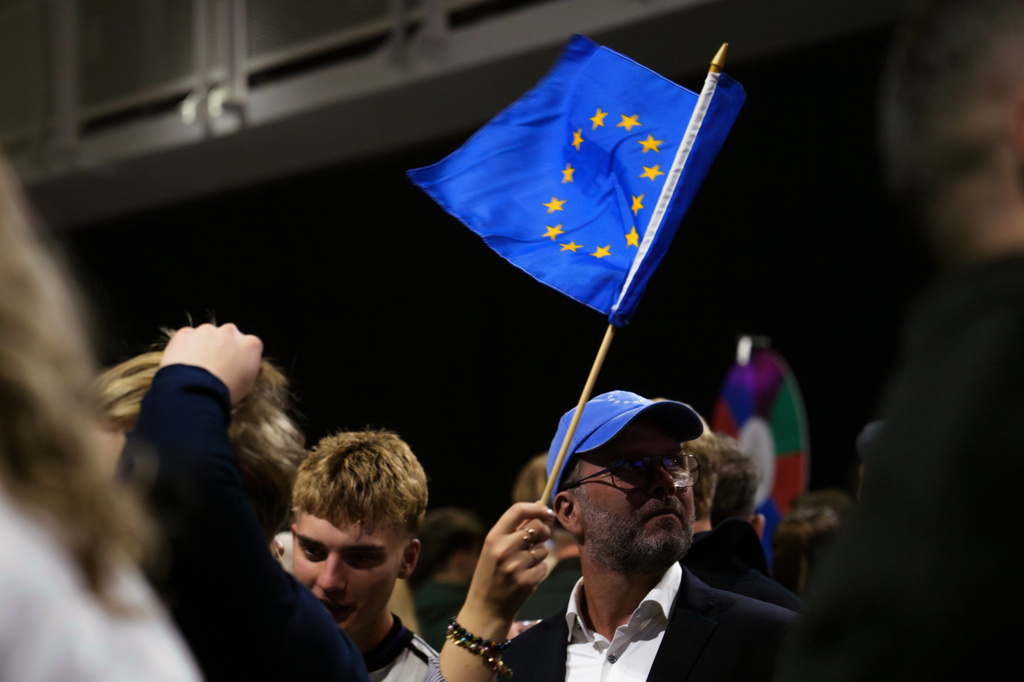 A supporter waves a European Union flag during an election-night gathering for the yes in Reykjavik, Iceland, Sunday, Aug. 30, 2026. (AP Photo/Marco Di Marco)