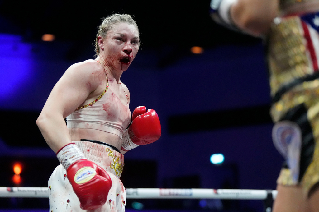 Boxer Lauren Price is bloodied during a welterweight title bout agasinst Stephanie Pineiro in Cardiff, Wales, Saturday April 4, 2026.(Nick Potts/PA via AP)