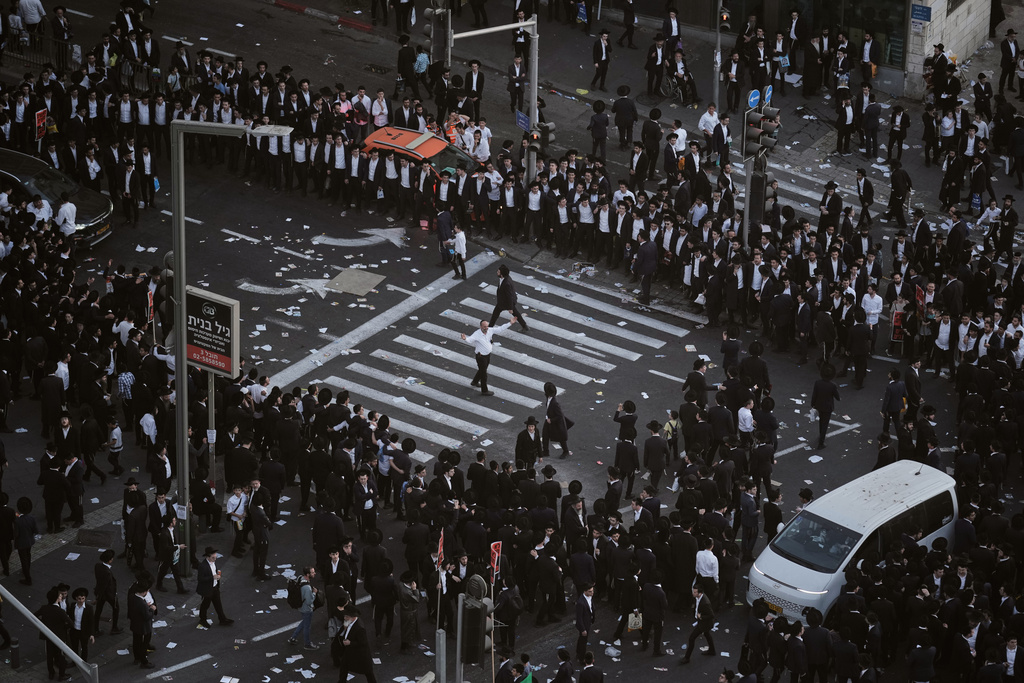Ultra-Orthodox Jewish men dance during a rally against plans to force them to serve in the Israeli military, in Jerusalem, Thursday, Oct. 30, 2025. (AP Photo/Leo Correa)