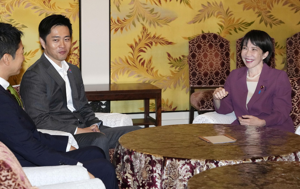 Sanake Takaichi, right, the leader of the ruling Liberal Democratic Party, meets with Hirofumi Yoshimura, second left, and Fujmitake Fuijta, leaders of of Nippon Ishin no Kai (Japan Innovation Party at the parliament in Tokyo, on Oct. 15, 2025. (Keisuke Hosojima/Kyodo News via AP)