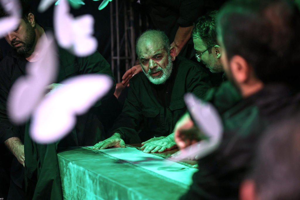In this photo released by Iran's Supreme Leader's office, Iran's paramilitary Revolutionary Guard Gen. Ahmad Vahidi sits alongside Iran's Supreme Leader Ayatollah Ali Khamenei casket as it lies in a mourning hall adjacent to the Imam Khomeini Hussainiya within the Supreme Leader's compound before his funeral in Tehran, Iran, late Thursday, July 2, 2026. (Office of the Iranian Supreme Leader via AP)