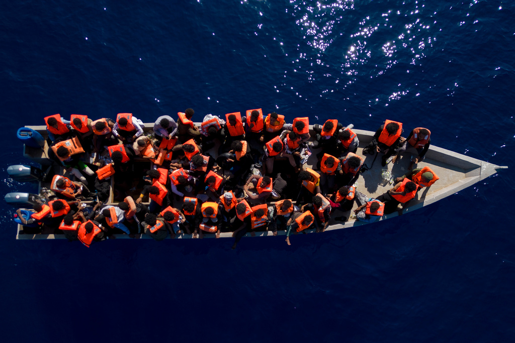 FILE - Migrants from Eritrea, Libya and Sudan sail a wooden boat before being assisted by aid workers of the Spanish NGO Open Arms, in the Mediterranean sea, about 30 miles north of Libya, Saturday, June 17, 2023. (AP Photo/Joan Mateu Parra, File)