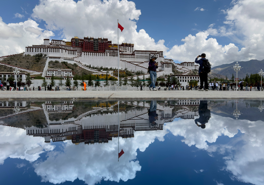 The Potala Palace is reflected off a polished tile on a square in Lhasa in western China's Tibet Autonomous Region on Tuesday, July 21, 2026, as seen during a government organized visit for foreign journalists. (AP Photo/Ng Han Guan)