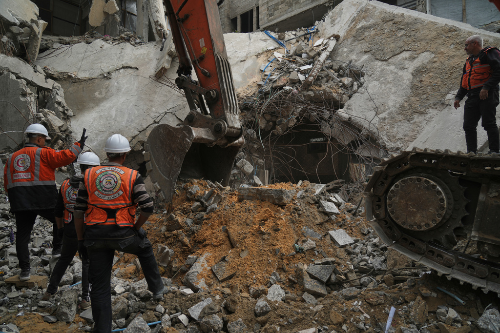 Gaza's civil defense teams work to recover the remains of members of the Abu Nada family, who remain trapped beneath the rubble of their four-story house after it was destroyed by an Israeli airstrike in December 2023, in Gaza City, Monday, Feb. 9, 2026. (AP Photo/Jehad Alshrafi)