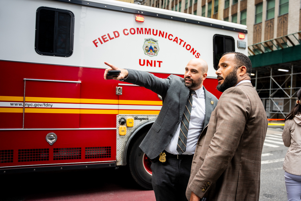 People point to the unstable building at 235 East 42nd Street, Tuesday, July 7, 2026, in New York. (AP Photo/Angelina Katsanis)
