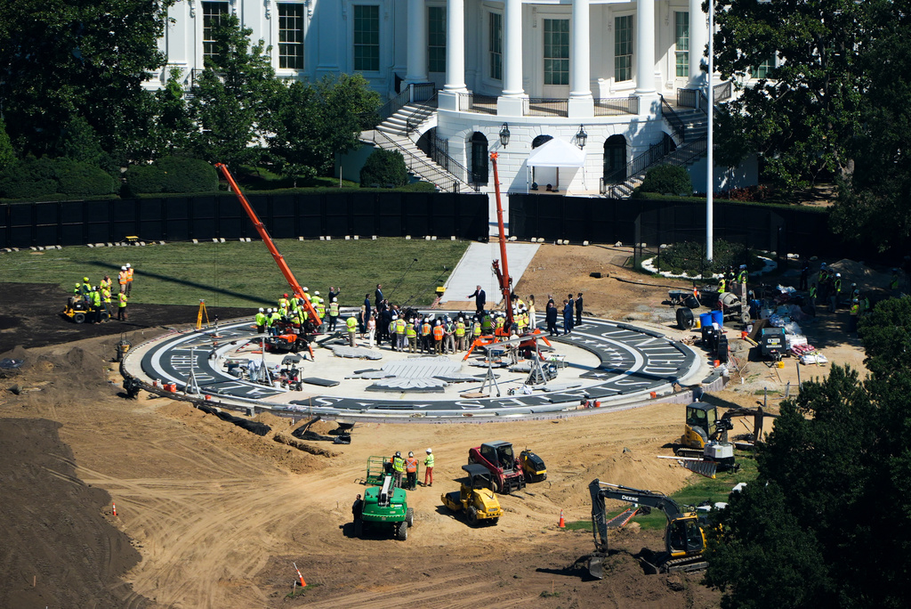 President Donald Trump speaks on the South Lawn of the White House at the construction site of the new helicopter landing zone, Wednesday, Aug. 19, 2026, seen from the Washington Monument in Washington. (AP Photo/Alex Brandon)