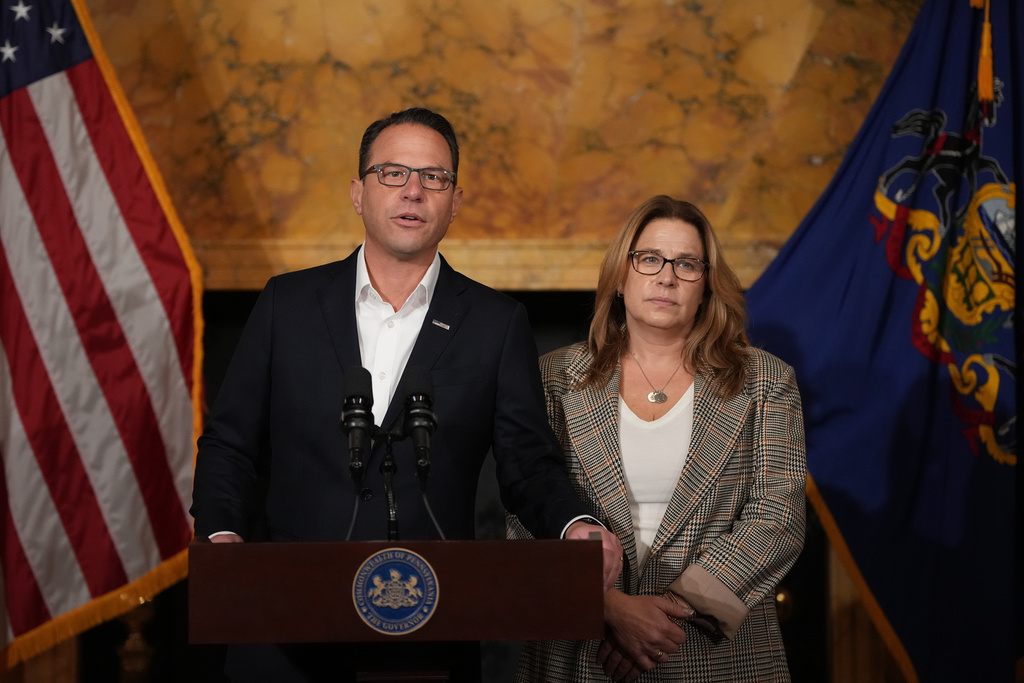 Pennsylvania Gov. Josh Shapiro, accompanied by his wife Lori Shapiro, speaks during a news conference after Cody Balmer plead guilty to attempted murder and other charges, on Tuesday, Oct. 14, 2025 in Harrisburg, Pa. (AP Photo/Matt Slocum)