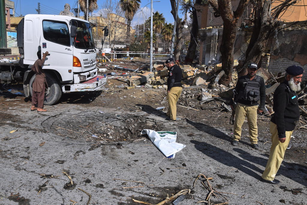 Police officers examine the site of Saturday's suicide bombing, in Quetta, Pakistan, Sunday, Feb. 1, 2026. (AP Photo/Arshad Butt)