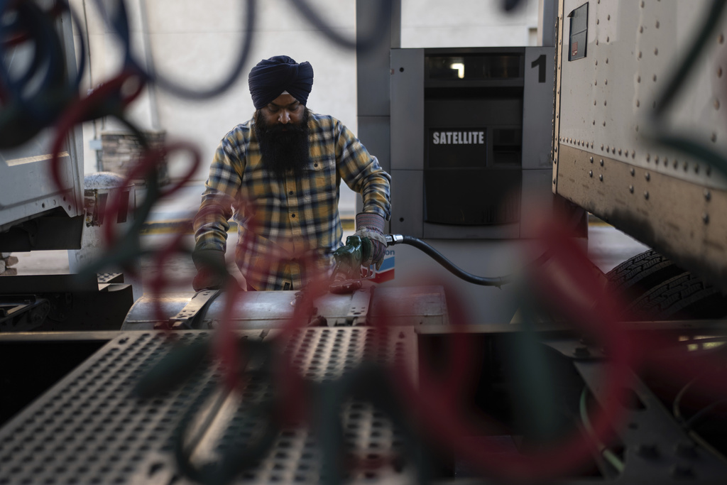 Sikh truck driver Prahb Singh fills up the tank of his truck at a gas station in Fontana, Calif., Wednesday, Sept. 3, 2025. (AP Photo/Jae C. Hong)