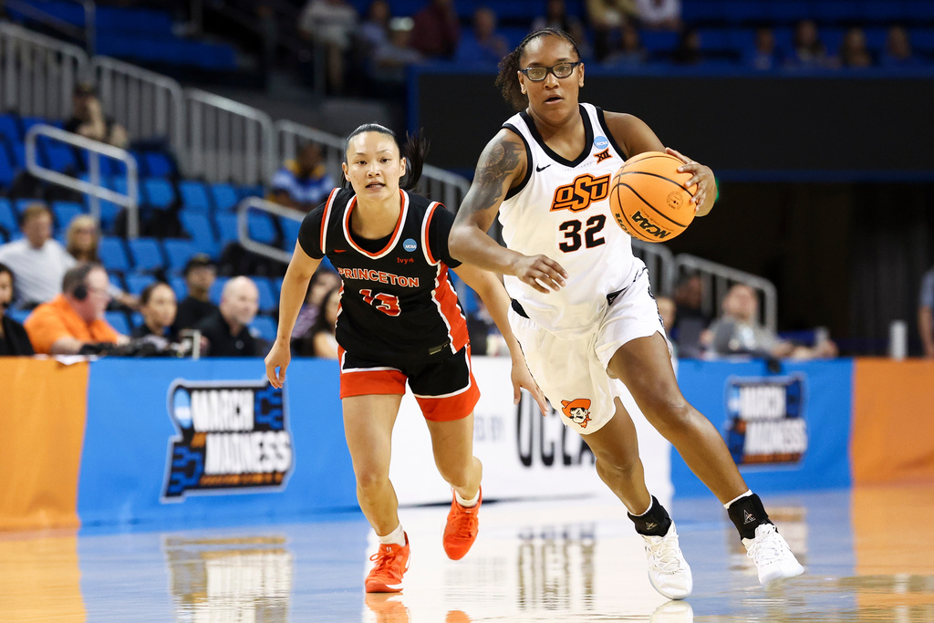 Oklahoma State guard Stailee Heard (32) dribbles as Princeton guard Ashley Chea, left, pursues during the first half in the first round of the NCAA college basketball tournament, Saturday, March 21, 2026, in Los Angeles. (AP Photo/Jessie Alcheh)