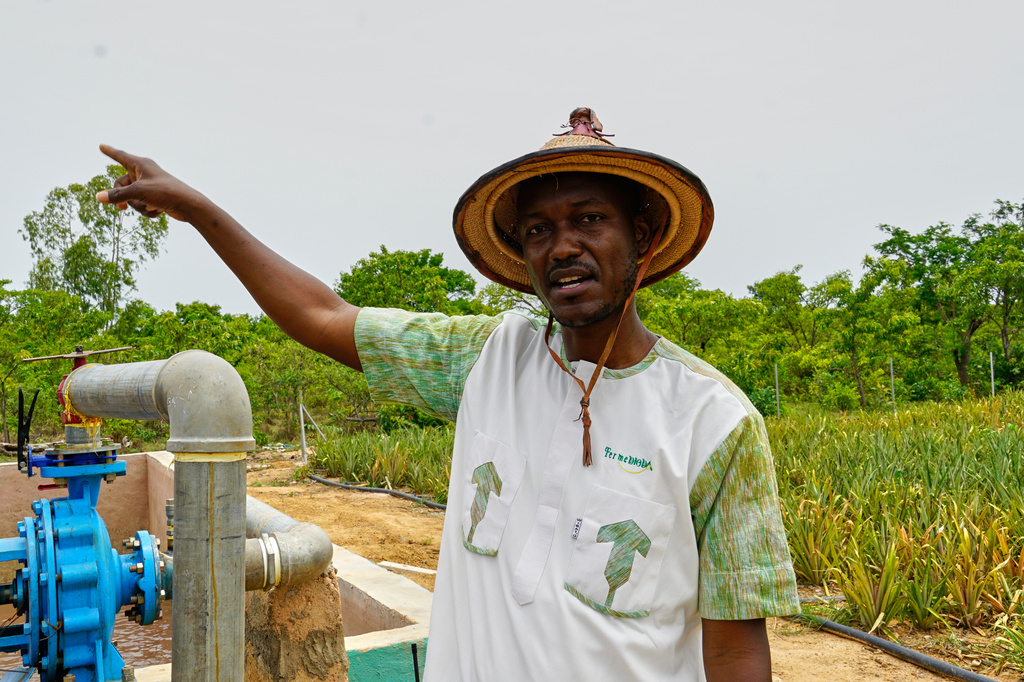 Farmer Oumarou Compaoré speaks to the Associated Press as he stands by one of the irrigation systems at Djoda Farm in Matourkou, near Bobo-Dioulasso, Burkina Faso, Thursday, May 7, 2026. (AP Photo/Elia Borras)