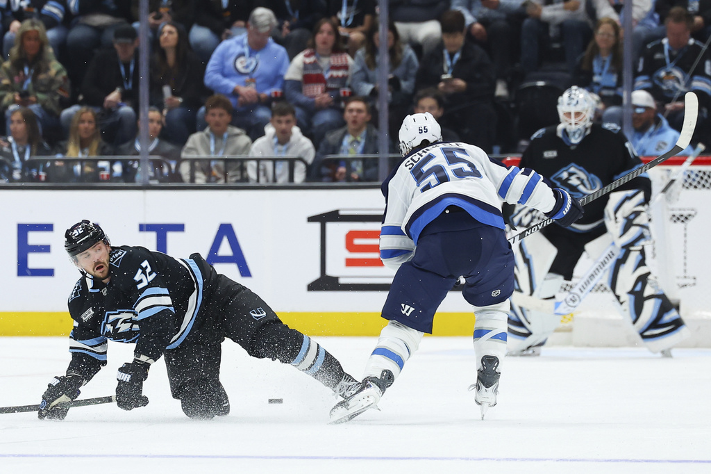 Winnipeg Jets center Mark Scheifele (55) scores on Utah Mammoth defenseman MacKenzie Weegar (52) during the third period of an NHL hockey game, Tuesday, April 14, 2026, in Salt Lake City. (AP Photo/Melissa Majchrzak)