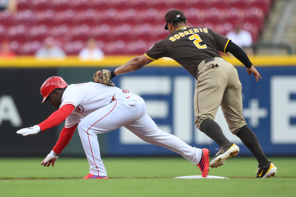 Cincinnati Reds' Héctor Rodríguez tries to stay on second after hitting a double as San Diego Padres shortstop Xander Bogaerts attempts to tag him out during the first inning of a baseball game, Tuesday, Sept. 1, 2026, in Cincinnati. (AP Photo/Tanner Pearson)